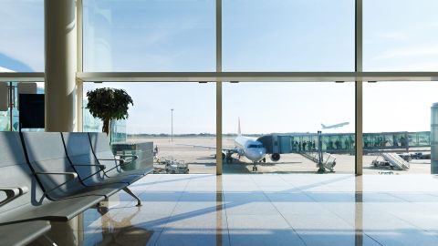 Airport terminal, people going to airplane in background