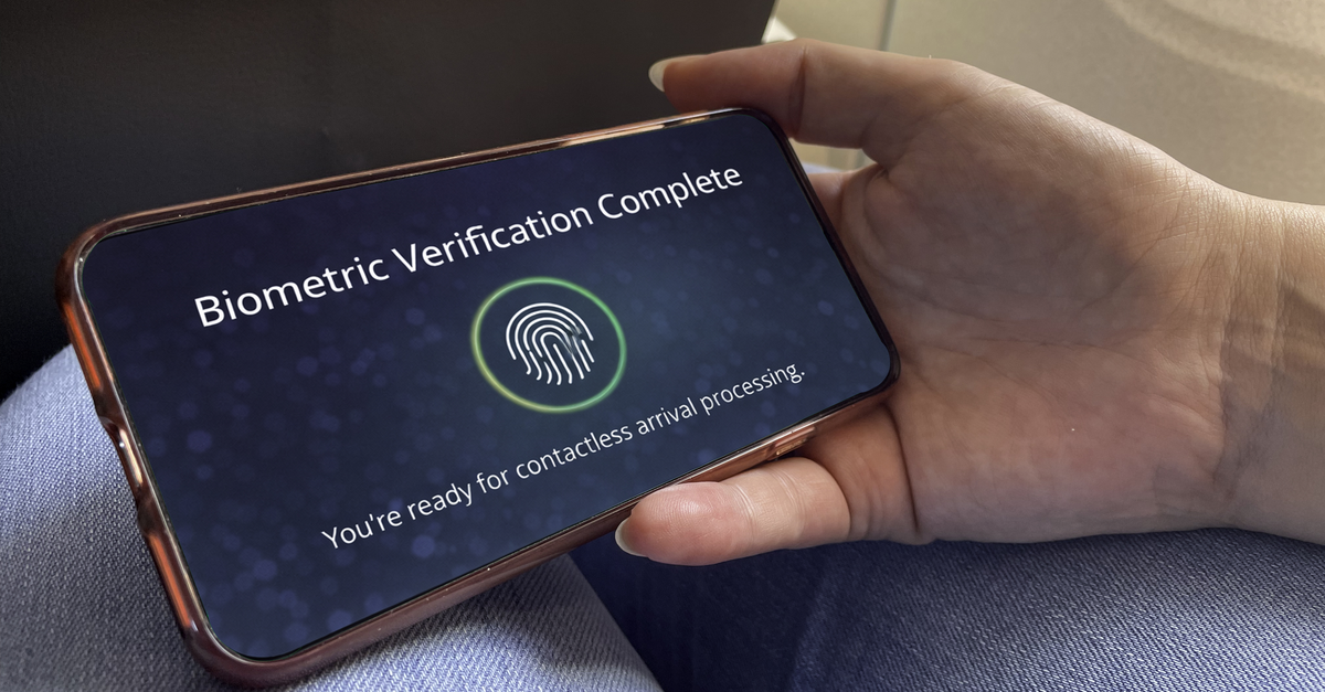 Close up of mobile phone screen stating "Biometric Verification Complete" and fingerprint symbol