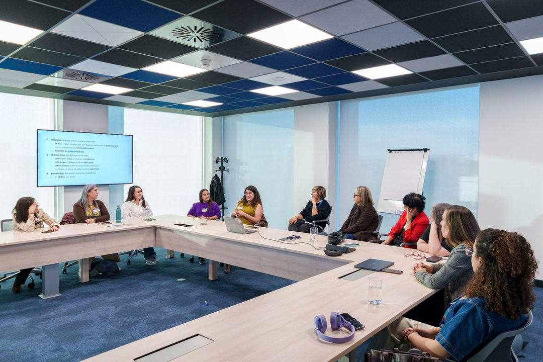 RTCE attendees seated around a conference table taking part in a small-group discussion.