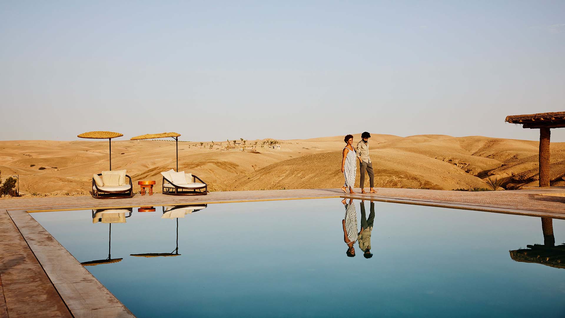 Couple walking by a pool at a resort