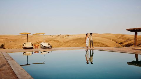 Couple walking by a pool at a resort