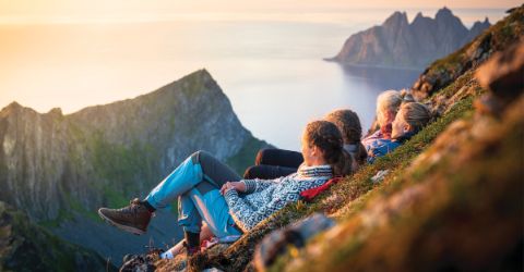 Cheerful young women watching sunset, Senja island, Norway