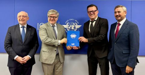 4 representatives from Amadeus and ICAO at signing ceremony holding the signed agreement