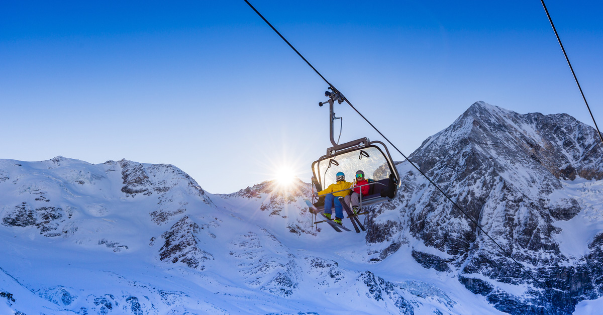 Snowy Norway steals the top spot this holiday season. Skiers on a ski lift head up the mountain.