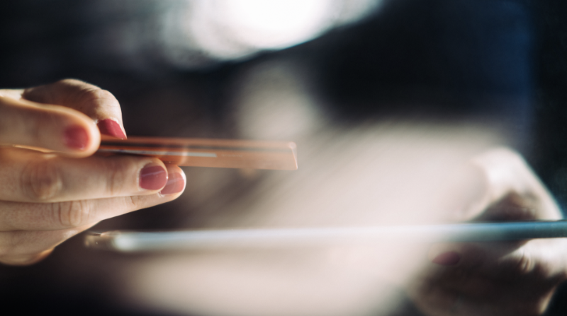 Using a card to make a payment via a tablet device.