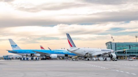 Air france and KLM planes at an airport with cloudy sky behind