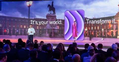 Cyril Tetaz on colorful stage at Altitude event, with big audience in front. 