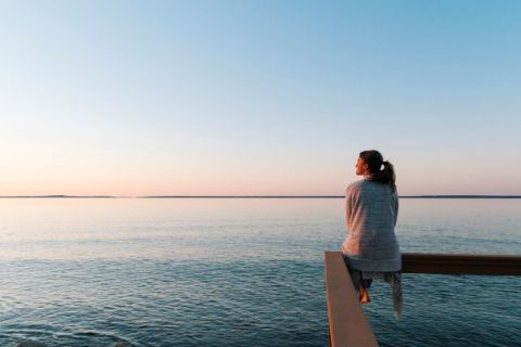 Woman overlooking the sea into the horizon 