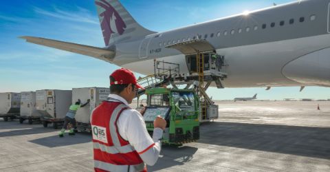 Airport ground handler staff standing in front of aircraft on tarmac