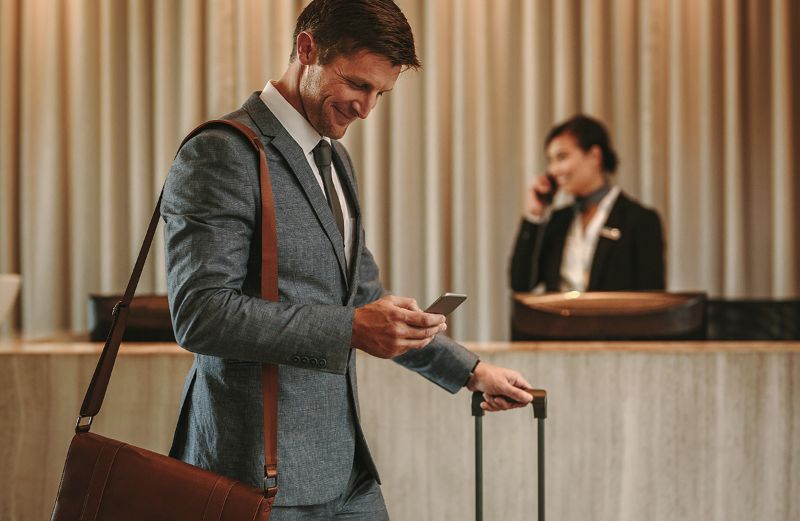 Businessman hotel lobby smartphone