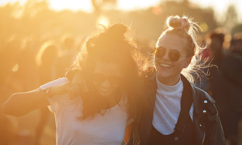 Two women attending event at sunset