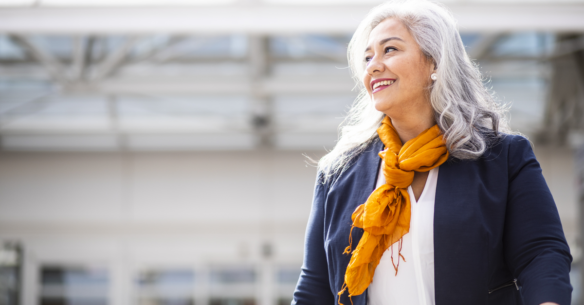 Hispanic smiling woman leaving the airport